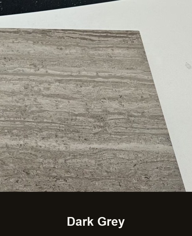 A cut sample of the dark grey board: a cool grey with stronger white veining running across it, photographed on a white bench.