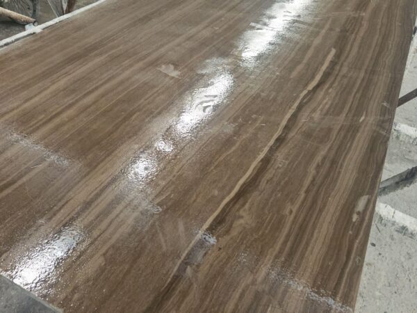 A slab on the polishing line, the face already taking the reflection of the overhead lights.