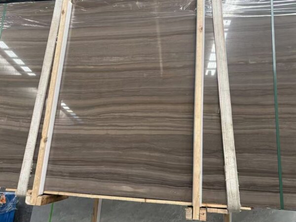A slab wrapped and banded for export, the timber frame and the plastic film both visible.
